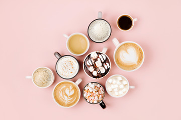 Various kinds of coffee in cups of different size   on pale pink background.  Coffee  Time concept....