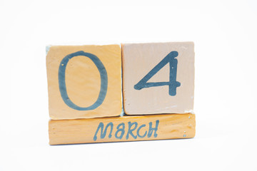 march 4th. Day 4 of month, handmade wood calendar isolated on white background. Spring month, day of the year concept.