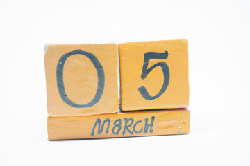 march 5th. Day 5 of month, handmade wood calendar isolated on white background. Spring month, day of the year concept.