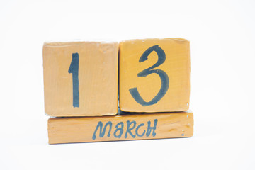 march 13th. Day 13 of month, handmade wood calendar isolated on white background. Spring month, day of the year concept.