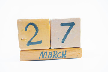 march 27th. Day 27 of month, handmade wood calendar isolated on white background. Spring month, day of the year concept.