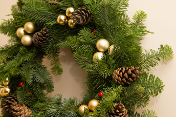 Fototapeta na wymiar Christmas natural wreath with natural decorations - pinecones, tangerines, dried apples.