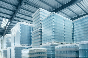 Interior of a modern warehouse in the blue toned. Warehouse with packed glass bottles. Interior of...