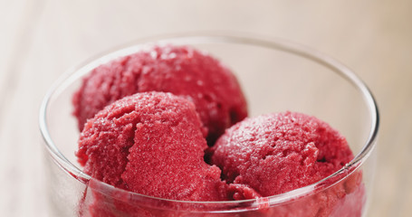 Closeup   of raspberry sorbet ice cream balls on wooden table