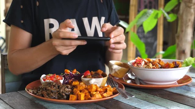 Closeup Of Woman Hands Taking Picture Of Vegan Healthy Food Using Cell Phone