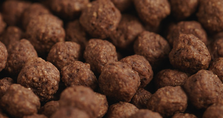 Closeup   of chocolate cereal balls in white bowl for breakfast on wooden table
