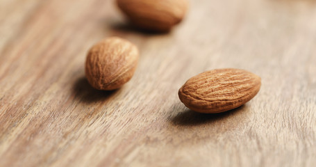 Closeup   of peeled almonds spread on old wooden table