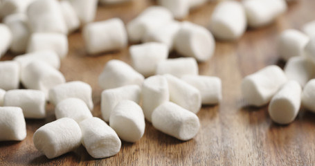 Fototapeta na wymiar Closeup of white marshmallows on wooden table
