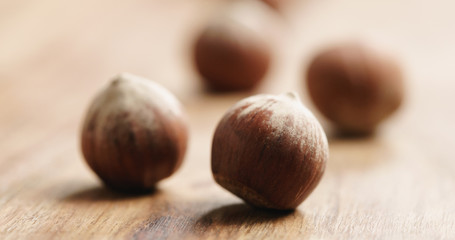 Closeup   of organic hazelnuts on old wooden table