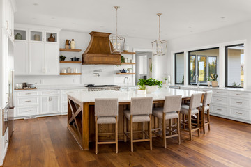 Beautiful Kitchen Interior in New Luxury Home with Large Island, Hardwood Floors, and White Cabinets and Countertops