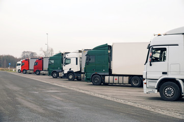 Parking by the highway. Trucks parked in a long row.