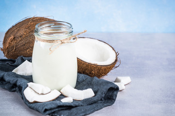 Coconut milk in glass jar. Vegan non dairy milk. 