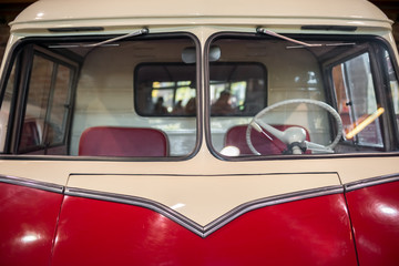 Front of retro car with windshield and steering wheel