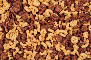  Chocolate flakes in the form of skulls and bones background. Top view.