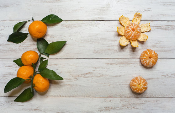 Peeled mandarins on a wooden table. Top view. 