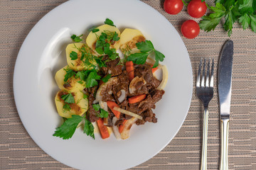 Roast meat with potatoes and carrots