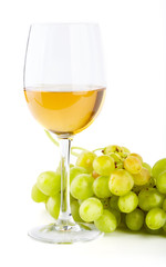 A glass of white wine with a bunch of green grapes on a white background. Alcoholic beverages.
