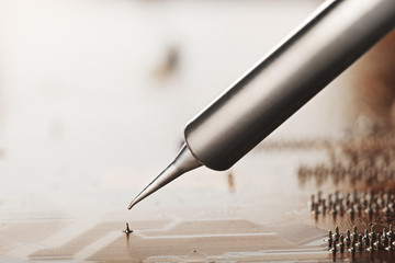 Work in progress. Soldering of electronic circuit board with electronic components. Soldering...