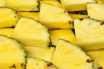 Pineapple juicy yellow slices background. Top view.