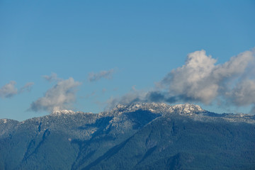 Mountain peak in snow with clear sky north of Canada.