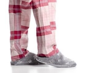 Women's feet in home slippers gray stars on white background isolation