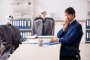 Funny business meeting with boss and skeletons