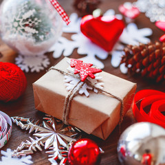 Christmas and New Year background with presents, ribbons, balls and different decorations on wooden background. Gift with Christmas tree symbol on it.