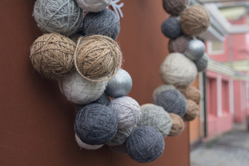 Christmas decorations in the form of woolen balls on a city street