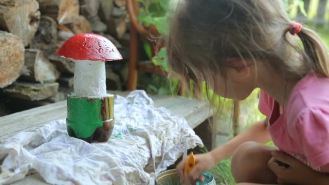 Little girl coloring garden decoration