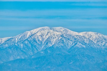 Snow capped mountains on blue sky