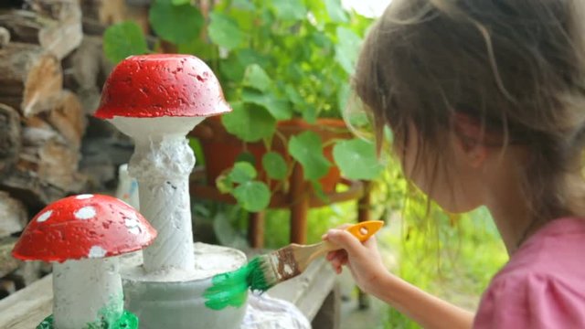 Little girl coloring garden decoration