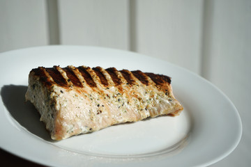 Grilled pork on the white plate.