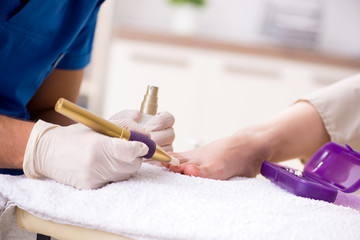 Podiatrist treating feet during procedure