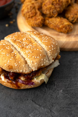 Hamburger and chicken strips on a wooden table. Fast food concept. 
