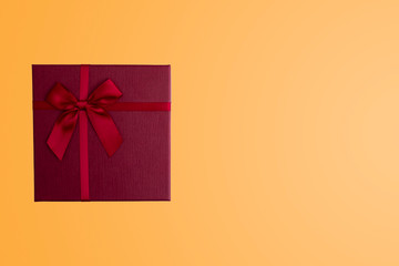 Red gift box on isolated yellow background