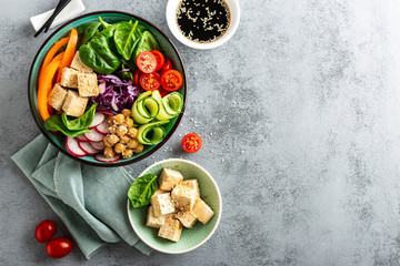 Buddha bowl salad with chickpeas, sweet pepper, tomato, cucumber, red cabbage kale, fresh radish,...