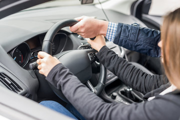 Fototapeta na wymiar Instructor's hand helping drive to a woman