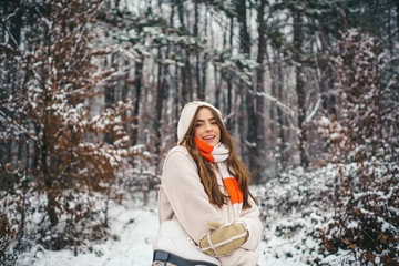 Sensual brunette winter girl posing and having fun. People in snow.
