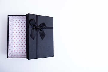 Black gift box with ribbon on isolated on white background