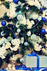 Christmas fir-tree,  christmas decorations and christmas gifts taken close up.