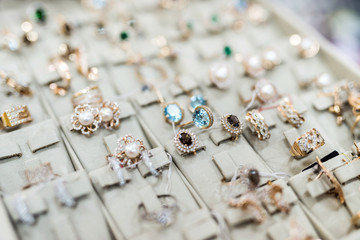 Collection of golden rings and earrings close up