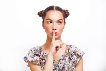Fototapeta premium Beauty teenage Model Girl thinking or choosing. Beautiful Joyful teen girl with freckles, funny hairstyle and yellow makeup . Professional make up.