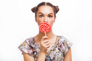 Fashion makeup. Beauty Girl Portrait holding Colorful lollipop. Hot red lips. Nail polish manicured nails. Skin care. Isolated on white background