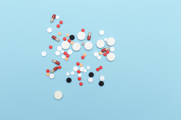 Medicine, colored  pills, capsules on blue background