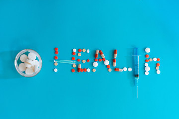 Health from assorted pharmaceutical pills scattered on blue background