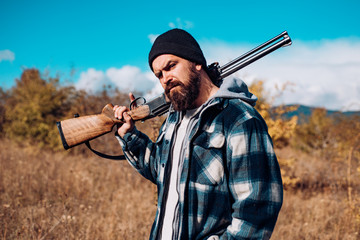 Hunter with shotgun gun on hunt. Gun rifle.