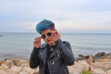 Young dark girl posing in front of the camera at a marine beach.