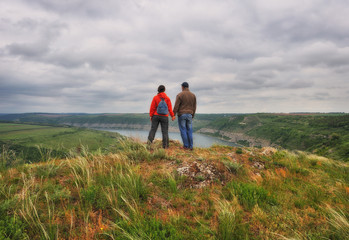 man and woman on the rock. tourist over the canyon of the Dniester River