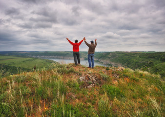 man and woman on the rock. tourist over the canyon of the Dniester River