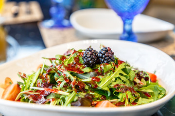 Salad with blackberries, arugula and strawberries, perhaps, that the bottom there is still something.